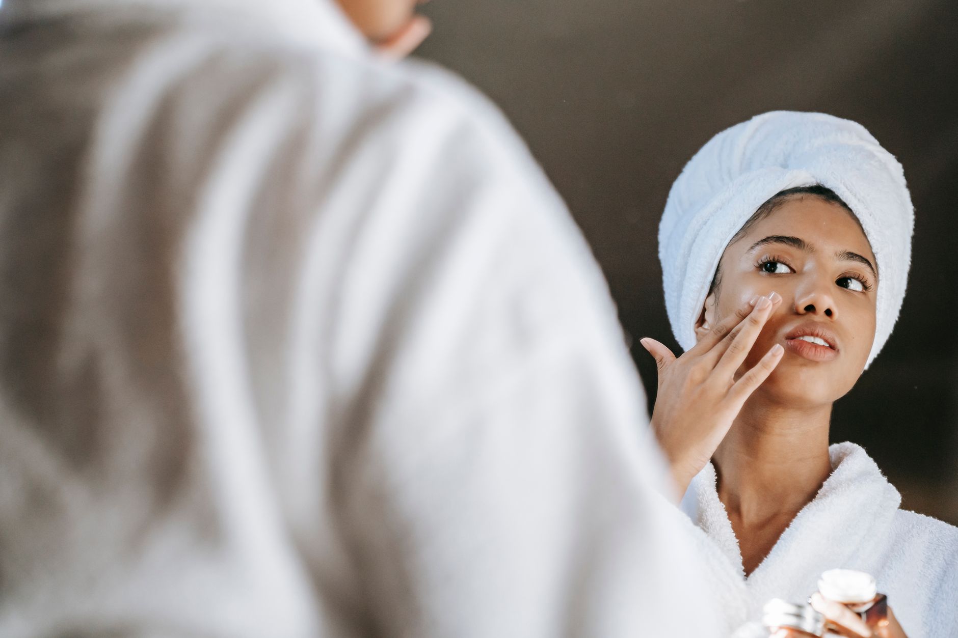 Femme en peignoir et serviette prenant soin de sa peau
